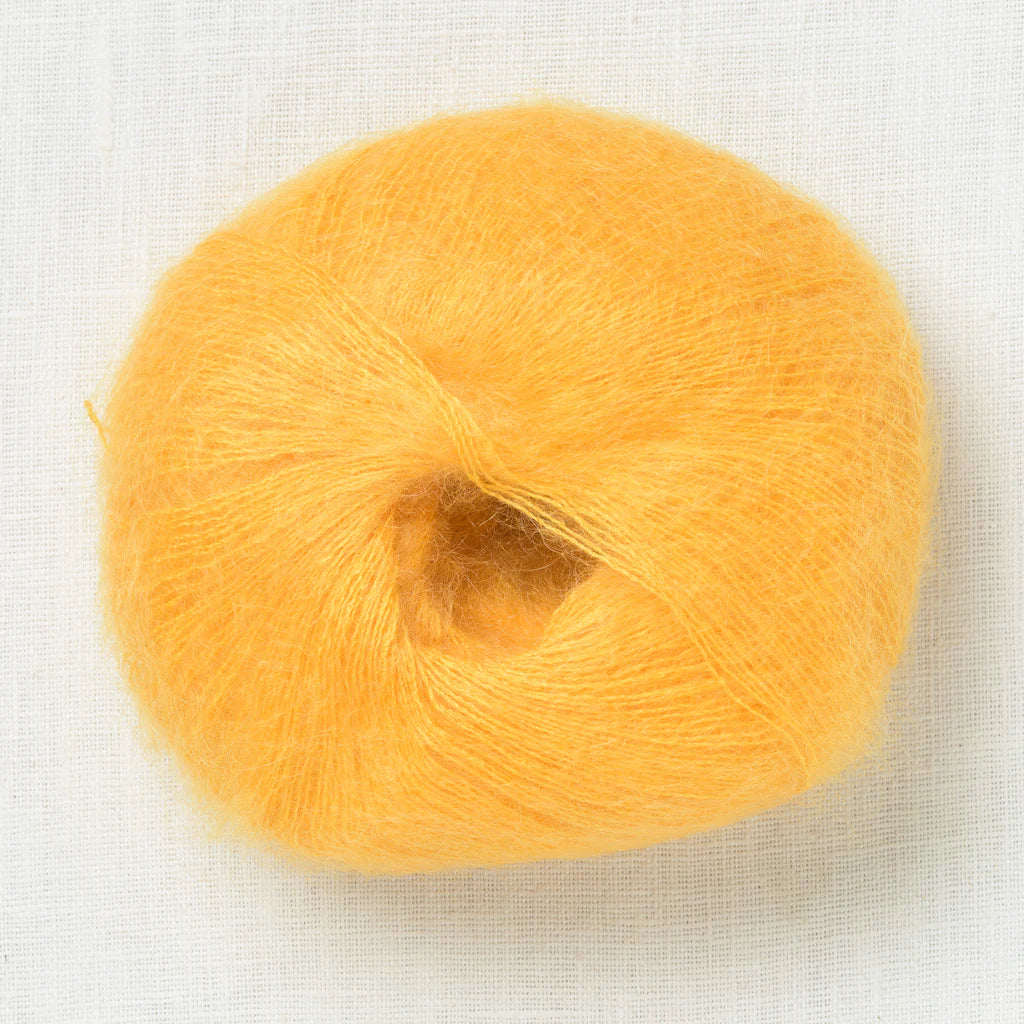 A fluffy ball of susnet yellow yarn.