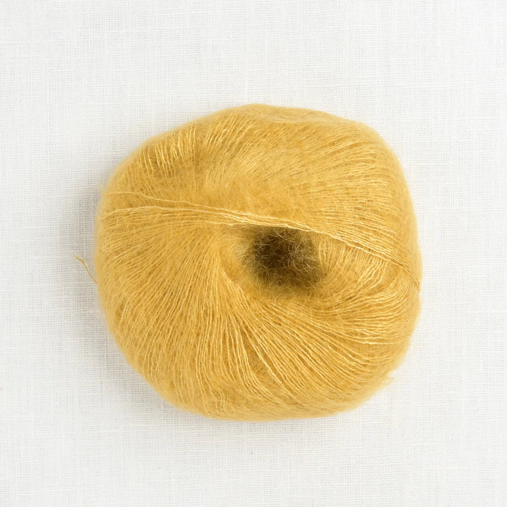 A fluffy ball of gold colored yarn.