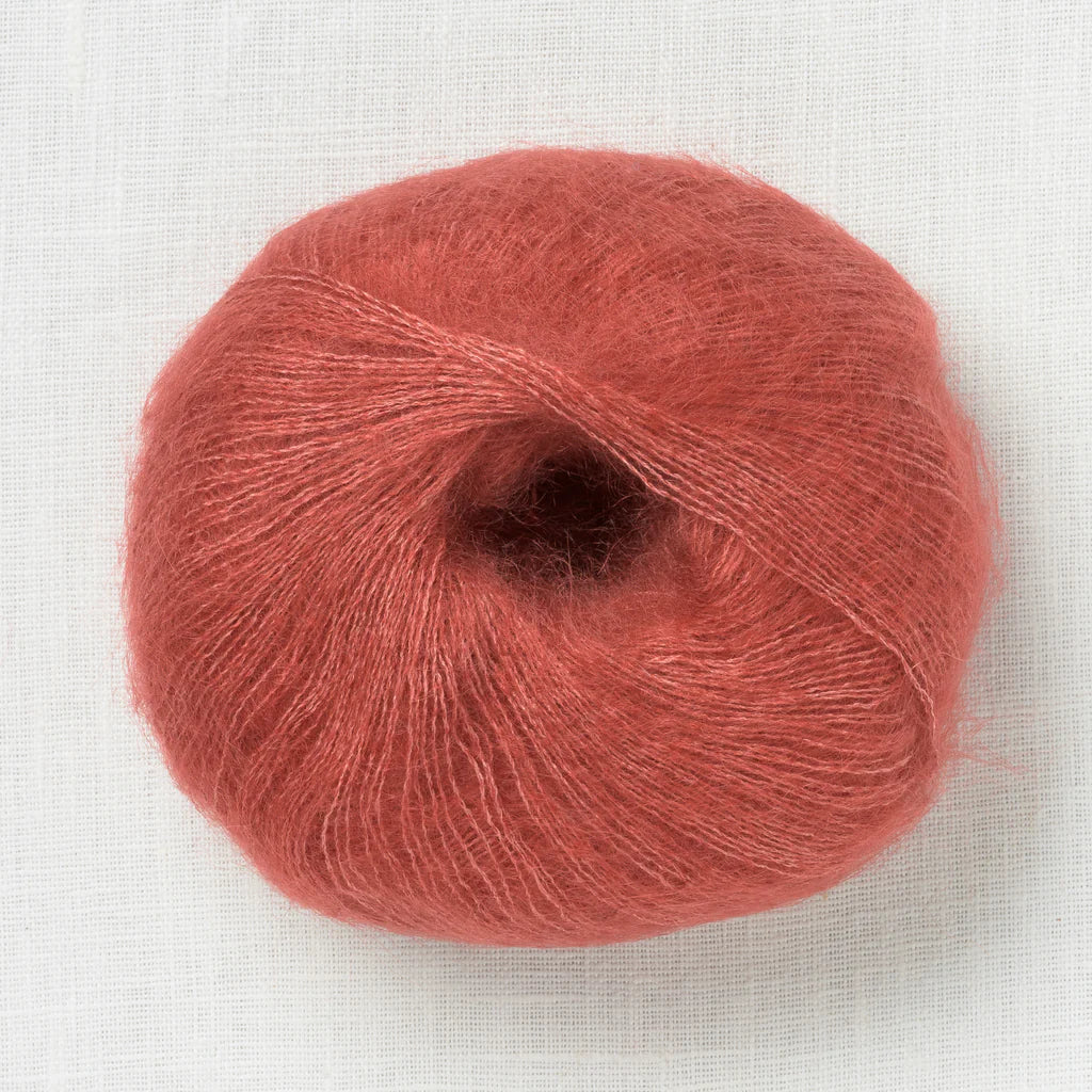 A fluffy ball of terracotta colored yarn.