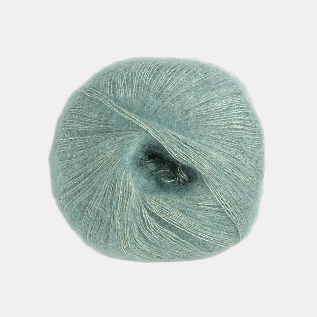 A fluffy ball of seafoam green yarn.