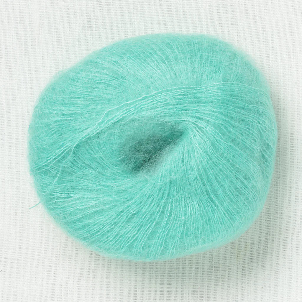 A fluffy ball of seafoam blue colored yarn.
