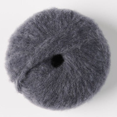Ball of dark grey fluffy alpaca yarn.