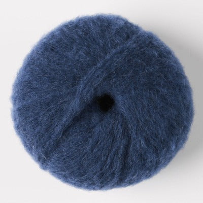 Ball of deep blue fluffy alpaca yarn.
