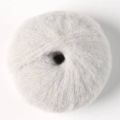 A ball of very light grey fluffy alpaca yarn.