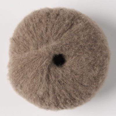 Ball of light moose brown fluffy alpaca yarn.