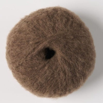 Ball of chocolate brown fluffy alpaca yarn.