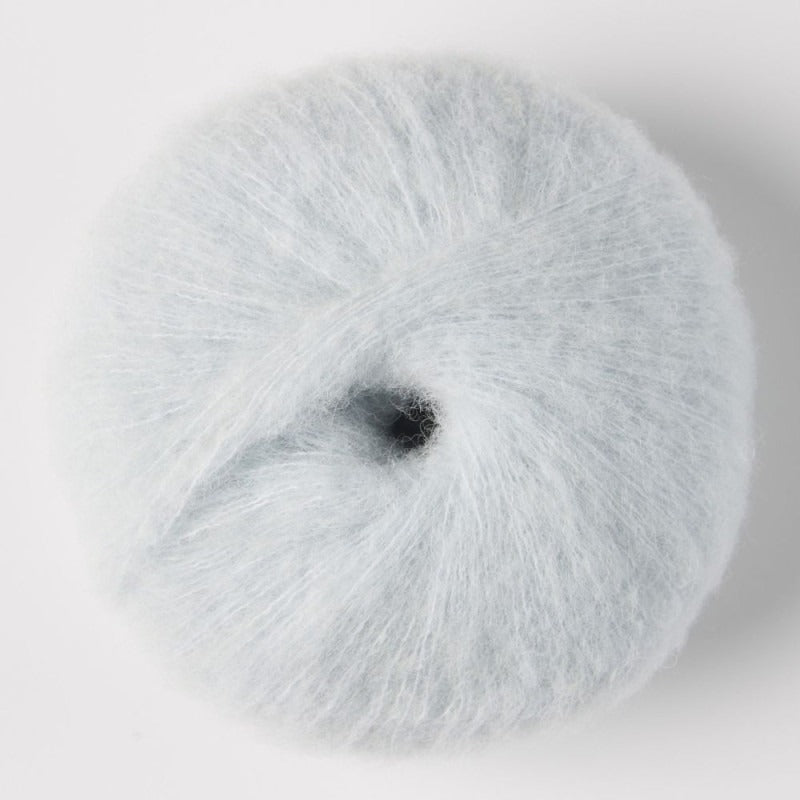 A ball of very light blue fluffy alpaca yarn.