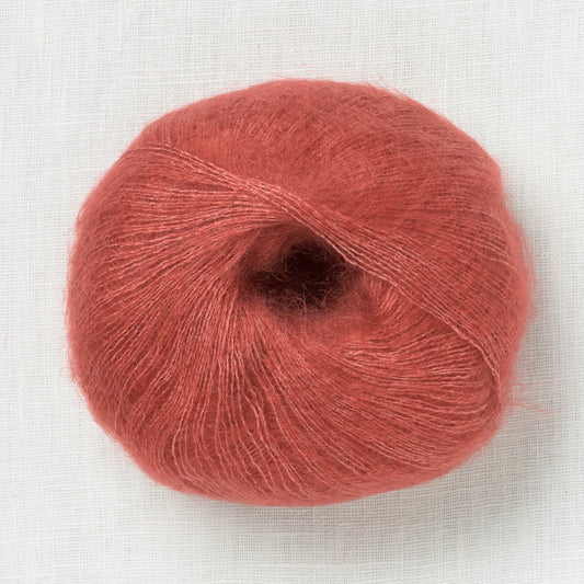 A fluffy ball of terracotta colored yarn. 