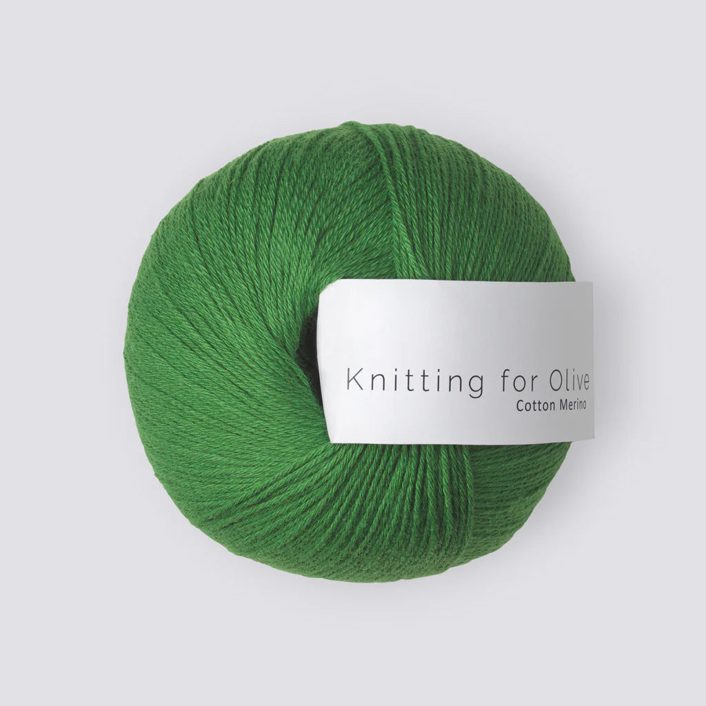 A ball of Kelly green yarn with a white 'Knitting for Olive' label, on a white background.