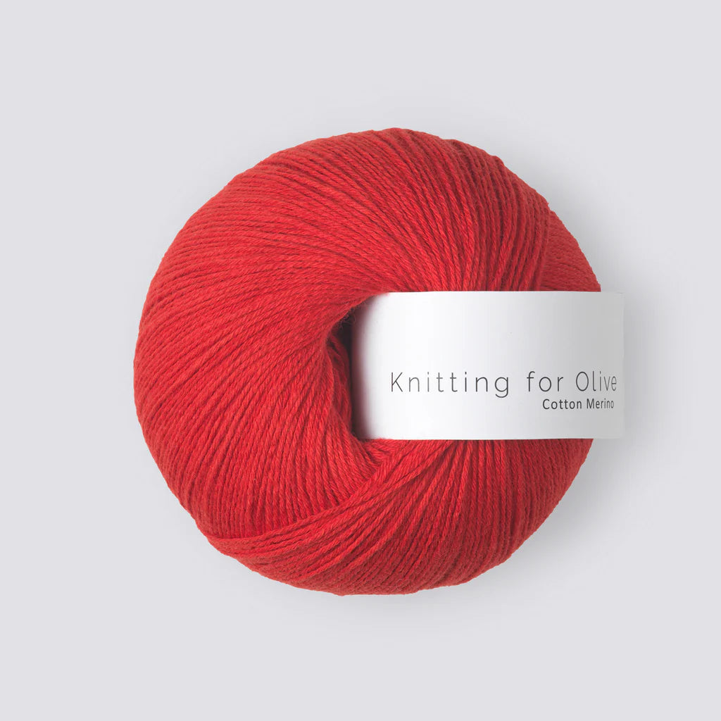 A ball of bright red yarn with a white 'Knitting for Olive' label, on a white background. 
