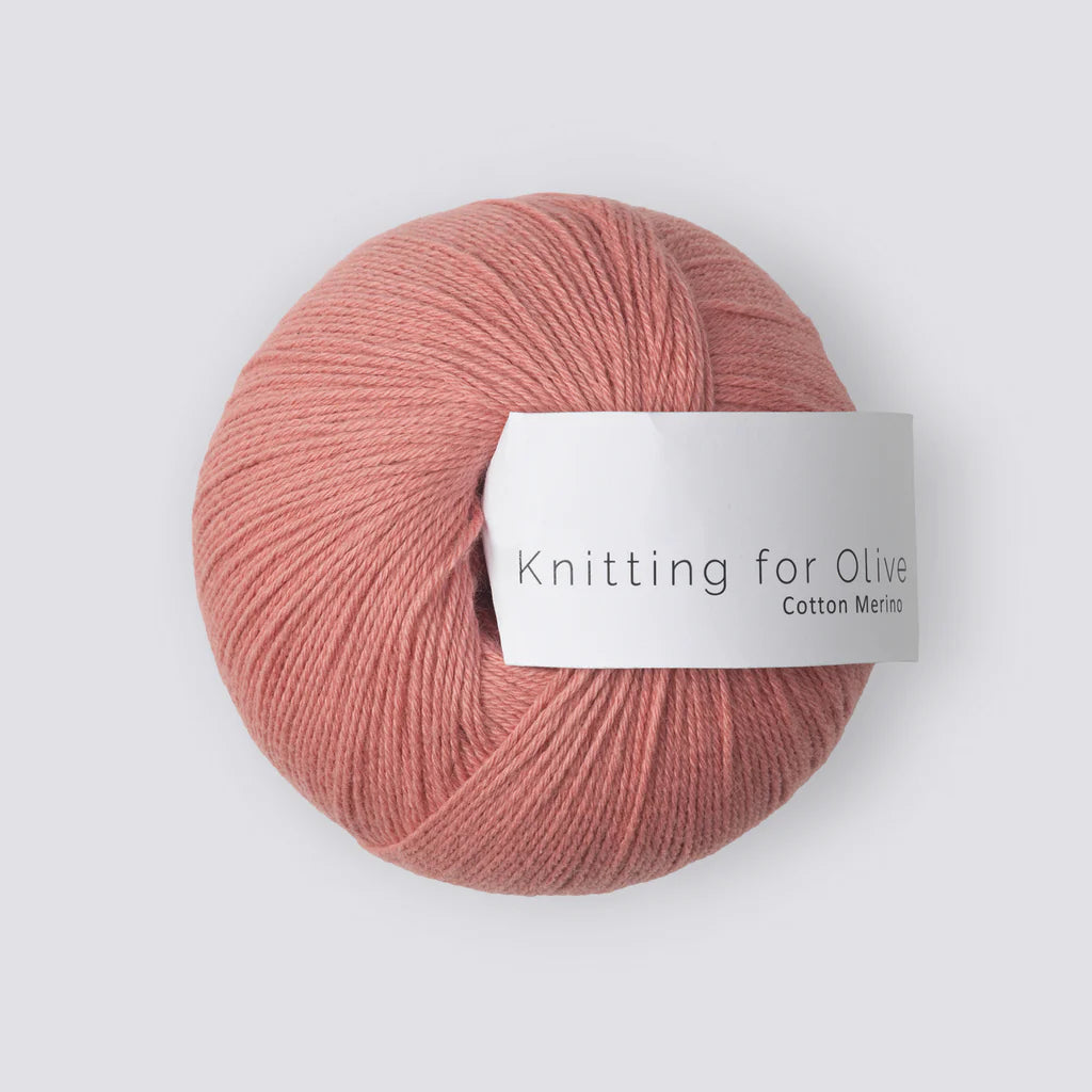 A ball of blush pink yarn with a white 'Knitting for Olive' label, on a white background. 