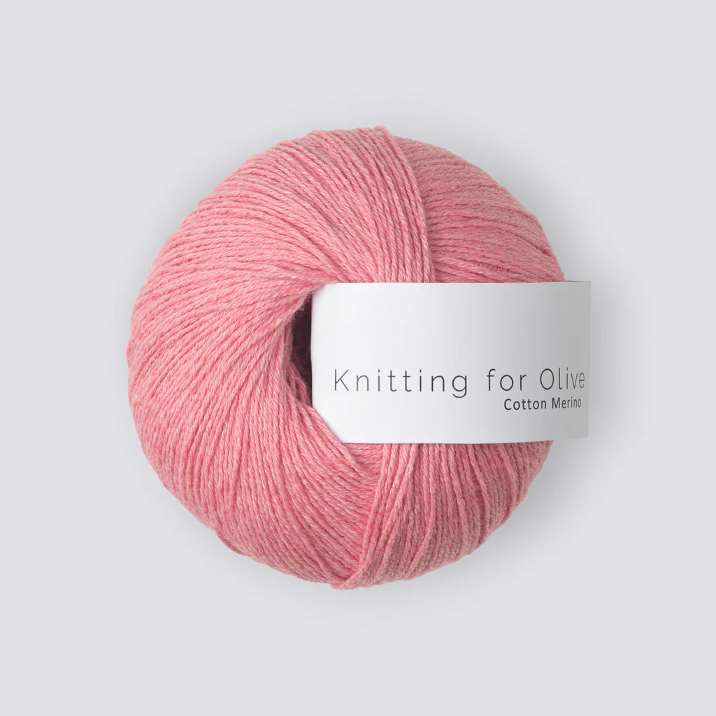 A ball of strawberry pink yarn with a white 'Knitting for Olive' label, on a white background. 