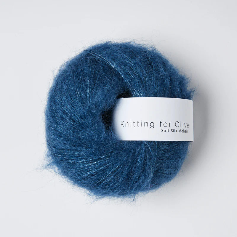 A ball of fuzzy deep ocean blue yarn.