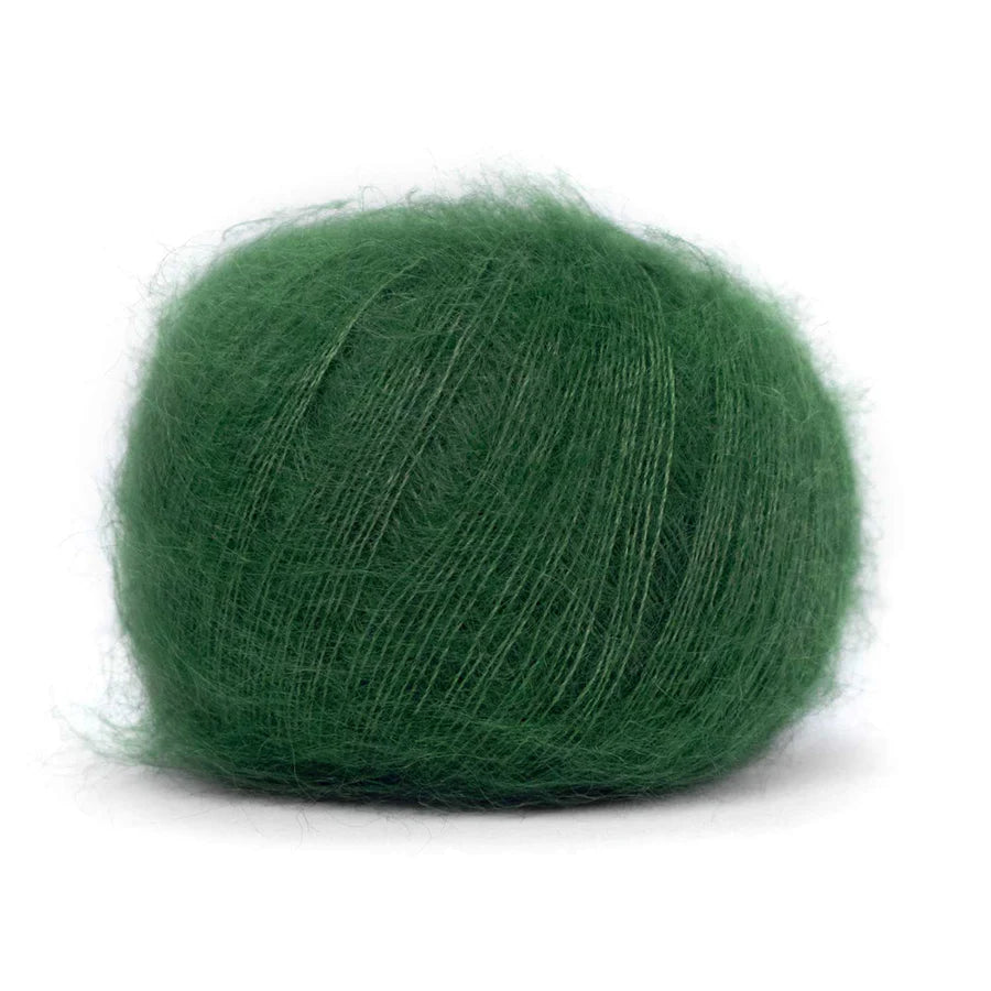 A ball of fluffy forest green yarn. 