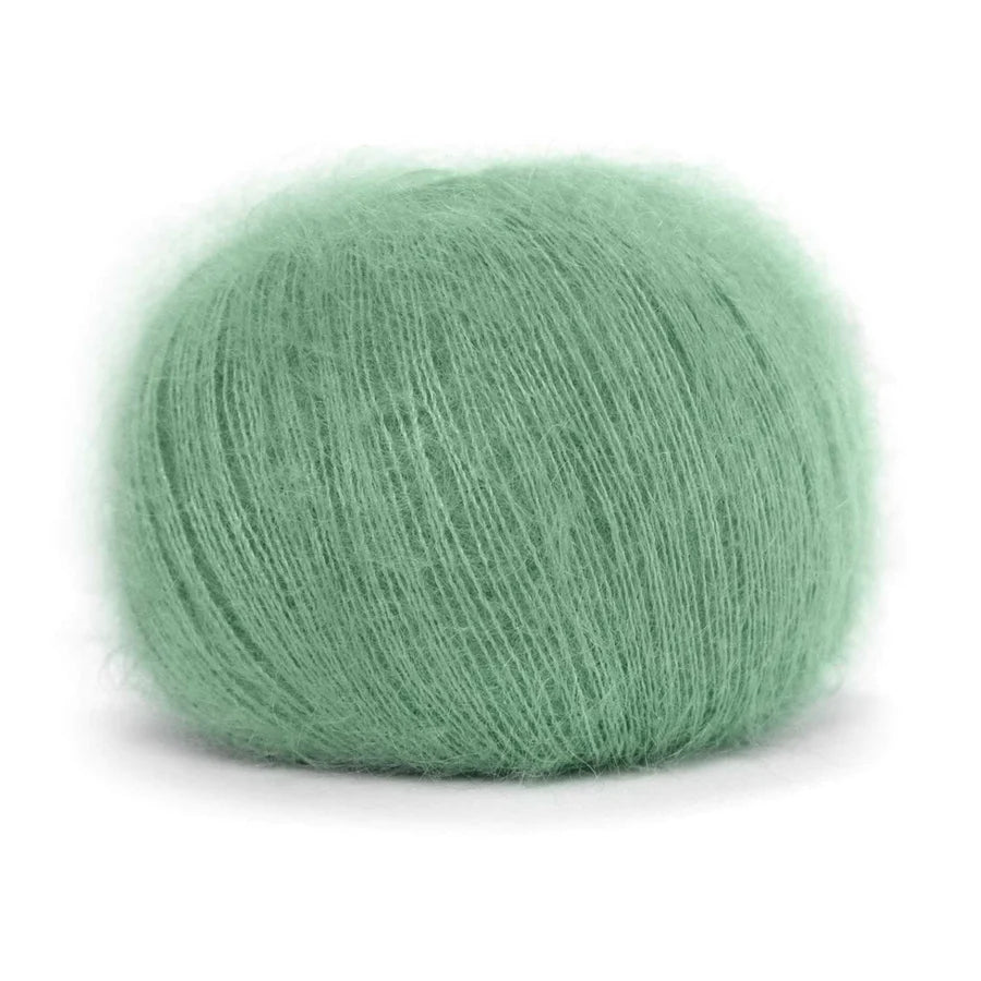 A ball of fluffy pastel mint green yarn. 
