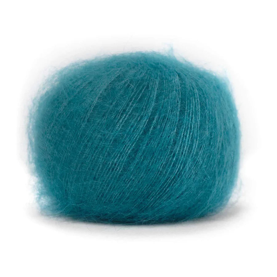 A ball of fluffy teal blue yarn. 