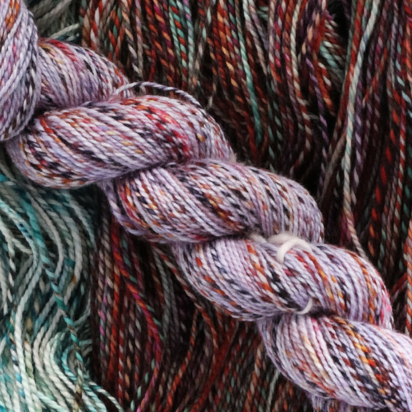 Close-up of braided yarn skeins in a variegated malabrigo Torzel colorway.