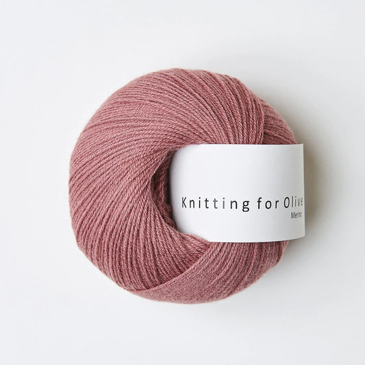 A ball of mauve pink colored yarn. 