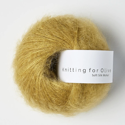 A ball of fuzzy gold mustard yarn. 